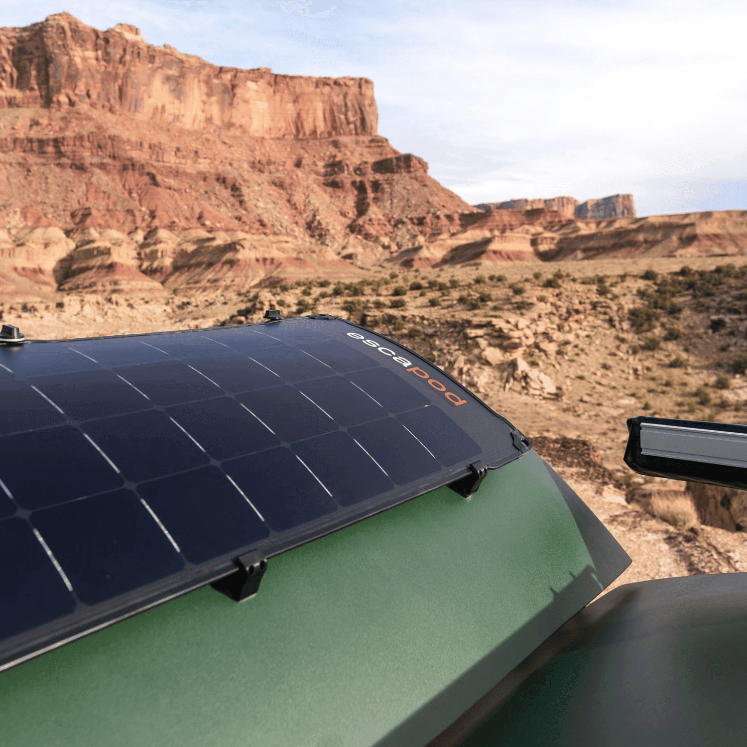 A solar panel on the back of a teardrop camper in full display, soaking up all the sun.