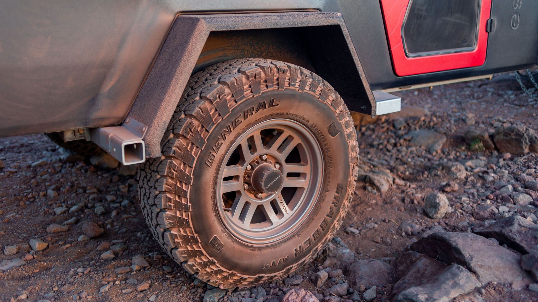 A close-up of the Escapod TOPO2 trailer’s rugged fender and off-road tire, highlighting the durable build for overland travel.